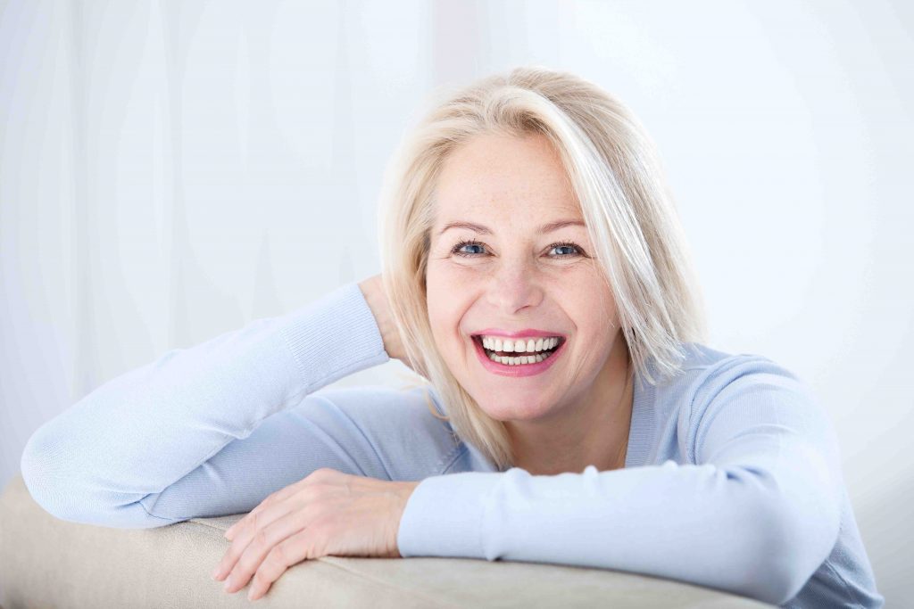 Middle age gray hair woman is smiling